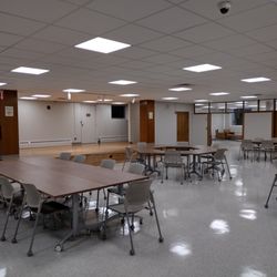 The auditorium in the lower level with stage and tables and chairs. This meeting space can be reserved. Visit buffalolib.org for details.