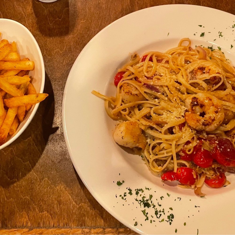 Montero's - Summer seafood pasta dish with a side of fries. - New American Near Me - Elizabeth City, North Carolina Montero's - Summer seafood pasta dish with a side of fries. - New American Near Me - Elizabeth City, North Carolina