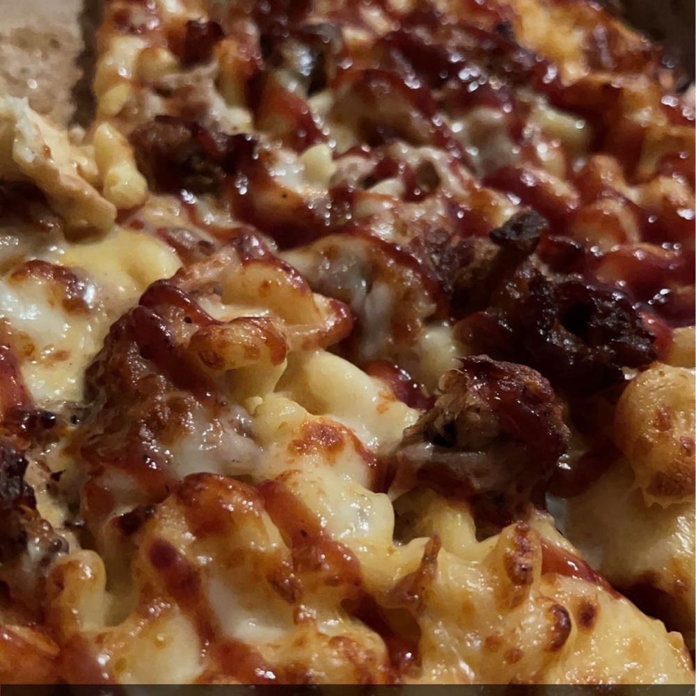 Sugar River Pizza - Mac n Cheese pizza topped with pulled pork and bbq drizzle - Pizza Near Me - Verona, Wisconsin Sugar River Pizza - Mac n Cheese pizza topped with pulled pork and bbq drizzle - Pizza Near Me - Verona, Wisconsin