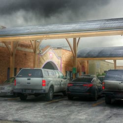 American Bush - Parking out front is shaded with... SOLAR PANELS! Let's hear it for the Bush going green.