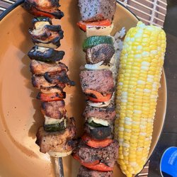 RB’s Tasty Treats And Delicious Dinners - Chicken and beef skewers with a side of corn on the cob.