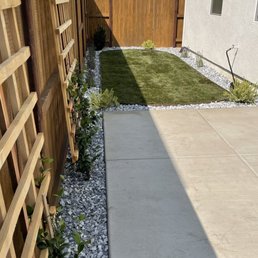 a concrete walkway and a fence
