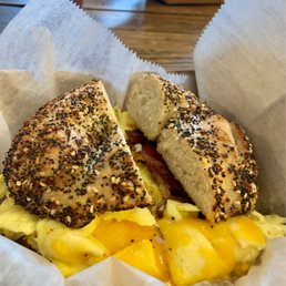 cheese, egg, and bacon on an everything bagel sandwich