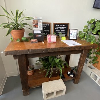 Power Up Nutrition - a wooden table with a plant on it - Coffee & Tea Near Me - Wilmington, North Carolina Power Up Nutrition - a wooden table with a plant on it - Coffee & Tea Near Me - Wilmington, North Carolina