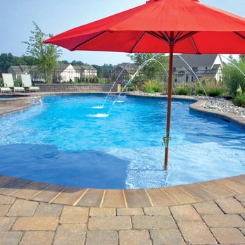 Blue Haven Pools & Spas - Free-form concrete pool with brick coping, laminar deck jets, and tanning ledge with integrated sun umbrella - General Contractors Near Me - Chico, California Blue Haven Pools & Spas - Free-form concrete pool with brick coping, laminar deck jets, and tanning ledge with integrated sun umbrella - General Contractors Near Me - Chico, California