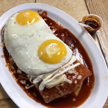 Gonzalez's Restaurant - Stephanie's Burrito with Birria. Red sauce and sunny side up eggs. Additional spicy sauce. - Mexican Near Me - Orange, California