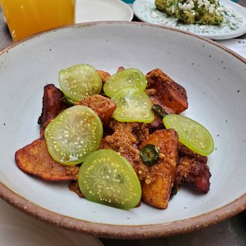 Carnal - Roasted potatoes with chorizo and tomatillos. Delicious - New American Near Me - Bellingham, Washington
