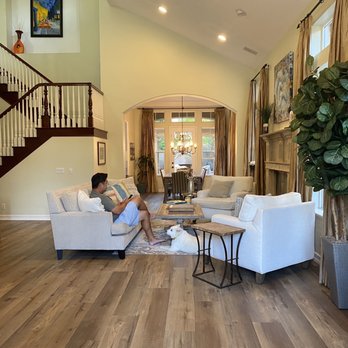 Beach City Flooring & Beyond - a woman sitting in a living room - Flooring Near Me - San Clemente, California