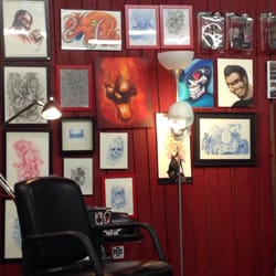 The Evil Emporium Of Tattoos - Pictures on wall and tattoo seating area