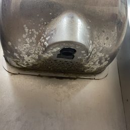 Mold on the hand dryer in the men's restroom.