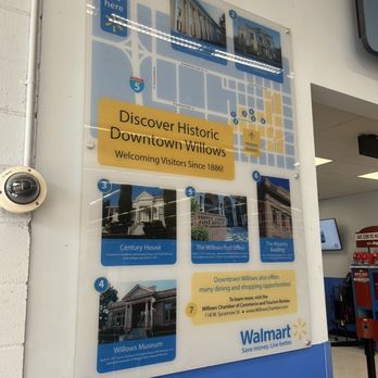Walmart Supercenter - The image shows a clear, mounted informational sign inside a Walmart store, displaying a map of downtown Willows with numbered points of interest. The sign includes photographs of historic buildings such as the Century House, Willows Post Office, and Willows Museum, along with descriptions and a welcoming message for visitors. The Walmart logo and slogan are visible at the bottom, and the sign provides directions and tourism information for exploring historic Willows. - Department Stores Near Me - Willows, California