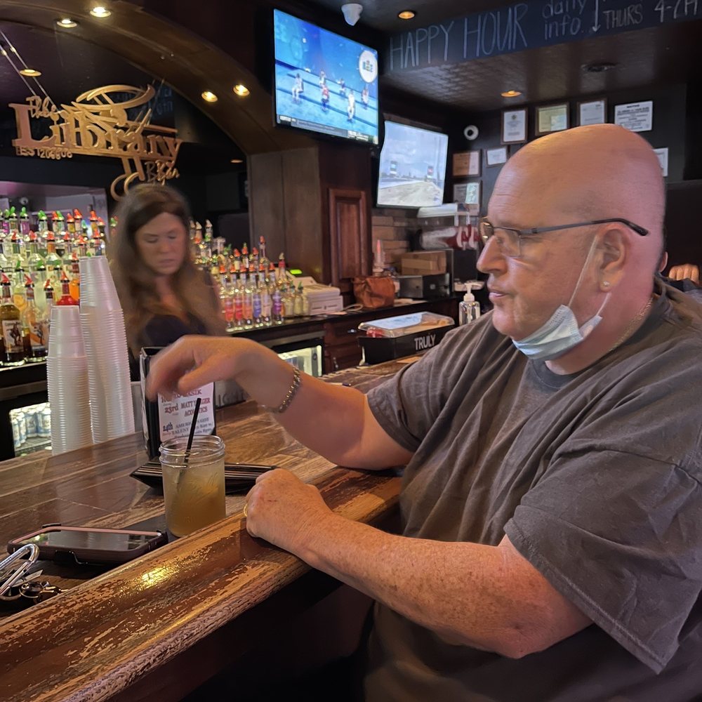 Library Bar - a man sitting at a bar - Beer Bar Near Me - Bourbonnais, Illinois Library Bar - a man sitting at a bar - Beer Bar Near Me - Bourbonnais, Illinois