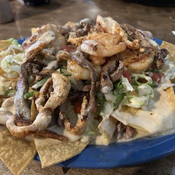 Gran Maya Mexican Restaurant - Shrimp, steak and chicken nachos. It's delicious!!  Easy on the sauce so you can actually taste the food. - Mexican Near Me - Ann Arbor, Michigan