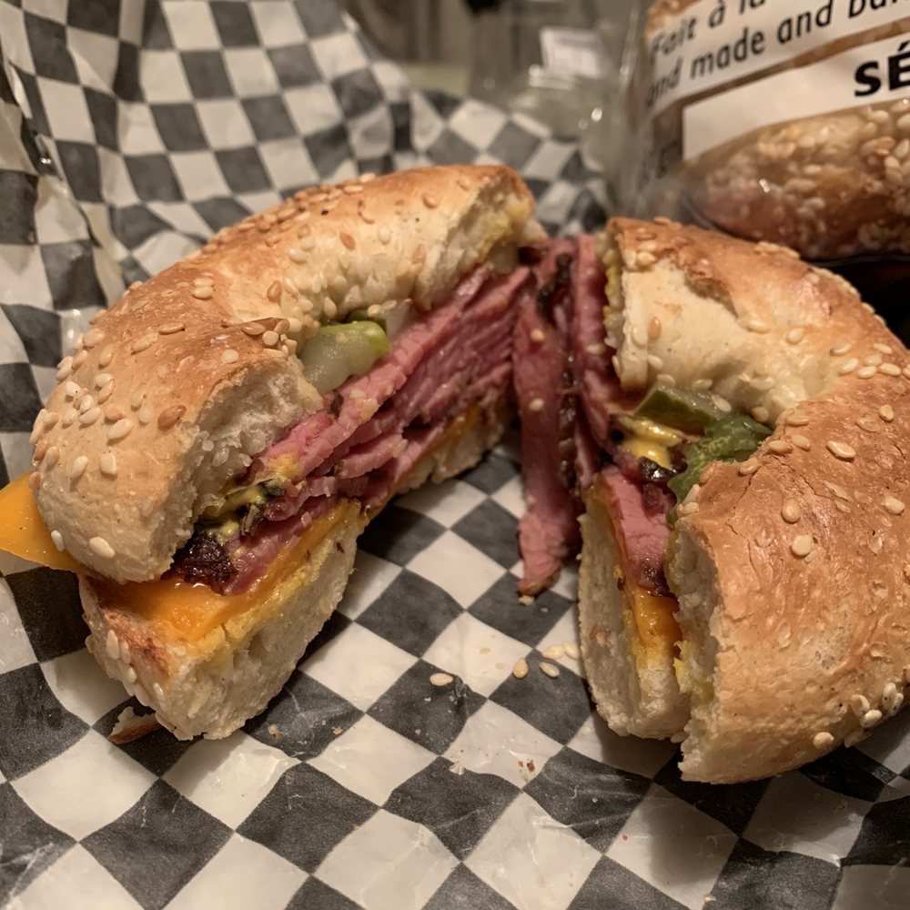 M.T.L. Bagel - a bagel sandwich with a bite taken out of it - Bagels Near Me - Côte Saint-Luc, Quebec M.T.L. Bagel - a bagel sandwich with a bite taken out of it - Bagels Near Me - Côte Saint-Luc, Quebec