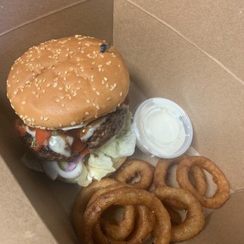 Retro Restaurant & Lounge - Huge 1/2 pound burger with onion rings. - New American Near Me - Seattle, Washington Retro Restaurant & Lounge - Huge 1/2 pound burger with onion rings. - New American Near Me - Seattle, Washington