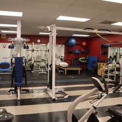 Carolina Physical Therapy and Sports Medicine - Fully equipped physical therapy gym in Forest Acres, SC, featuring specialized treatment for knee, shoulder, spine, and foot injuries.