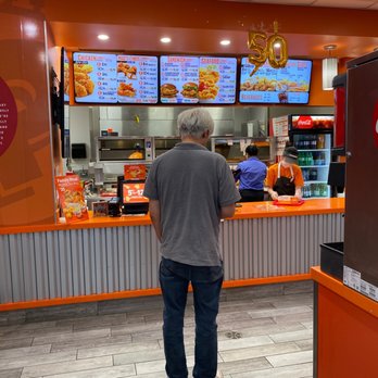 Popeyes - a man standing in a fast food restaurant - Chicken Wings Near Me - Burnaby, British Columbia Popeyes - a man standing in a fast food restaurant - Chicken Wings Near Me - Burnaby, British Columbia