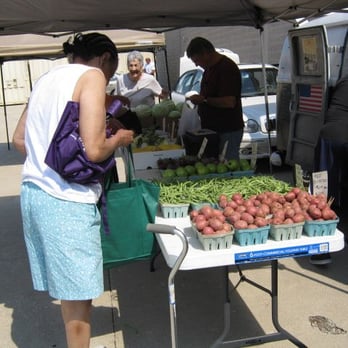 Columbus Square Farmer's Market - a woman buying vegetables - Farmers Market Near Me - Columbus, Ohio