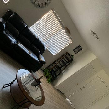 Purple Heart Construction - a living room with a clock on the wall - General Contractors Near Me - Carson, California