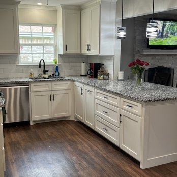 Hernandez Remodeling - a kitchen with white cabinets and wood floors - General Contractors Near Me - Amarillo, Texas Hernandez Remodeling - a kitchen with white cabinets and wood floors - General Contractors Near Me - Amarillo, Texas