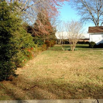No Hassle Maintenance - a yard with a fence and a house in the background - Landscaping Near Me No Hassle Maintenance - a yard with a fence and a house in the background - Landscaping Near Me