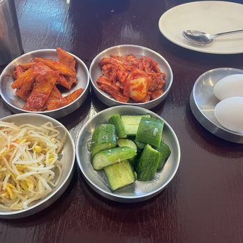 My Tofu House - Banchan (side dishes of fish cake, kimchi, cucumbers soaked in rice vinegar, bean sprouts, and egg to crack into tofu stew) - Korean Near Me - San Francisco, California My Tofu House - Banchan (side dishes of fish cake, kimchi, cucumbers soaked in rice vinegar, bean sprouts, and egg to crack into tofu stew) - Korean Near Me - San Francisco, California