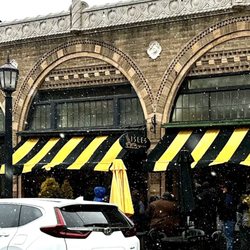 Isles Bun & Coffee - Store front as snow falls and people wait their turn
