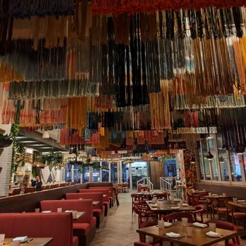 Joy by Seven Reasons - Dinning area interiors. Beautiful tapestries suspended from ceiling. - Latin American Near Me - Chevy Chase, Maryland Joy by Seven Reasons - Dinning area interiors. Beautiful tapestries suspended from ceiling. - Latin American Near Me - Chevy Chase, Maryland