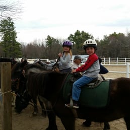 2 happy kids on ponies for a beginner trail ride. 2 happy kids on ponies for a beginner trail ride.