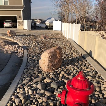 Three Points Landscape and Design - a red fire hydrant in a rock garden - Landscaping Near Me Three Points Landscape and Design - a red fire hydrant in a rock garden - Landscaping Near Me