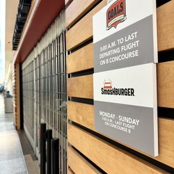 Louisville Muhammad Ali International Airport - Sign advertising Coals Artisian Pizza and Smashburger.