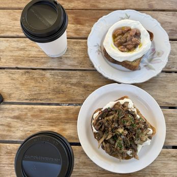 Bica - Two different toasts & lattes. Top ricotta & fruit jam, bottom mushroom. - Mediterranean Near Me - San Diego, California Bica - Two different toasts & lattes. Top ricotta & fruit jam, bottom mushroom. - Mediterranean Near Me - San Diego, California