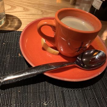 Brandl - a cup of coffee on a saucer with a spoon - New American Near Me - Belmar, New Jersey