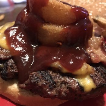 Rooster's Grille & Pizzaria - Close up of my western burger. Amazingly delicious onion rings!! My bro ordered a side of them and they were so good! - American Near Me - Calhan, Colorado