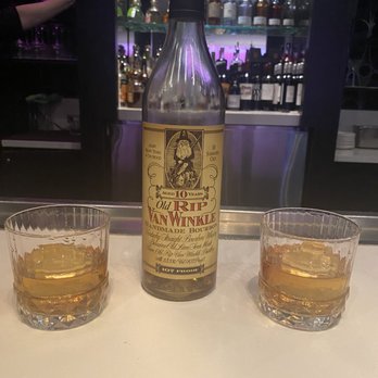 The Living Room - two glasses and a bottle of whiskey - New American Near Me - Minneapolis, Minnesota