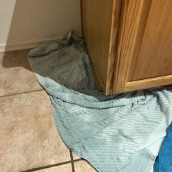 Christie's Appliance & Mattress Company - Towel saturated from water leaking out from under kitchen cabinets