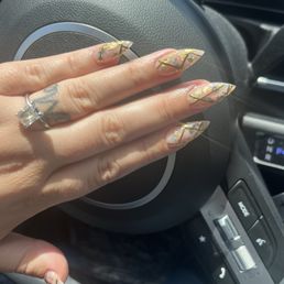 Showed him a photo and he elevated the design ! Acrylic stiletto.