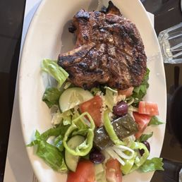 Pork chop with Greek side salad. Pork chop with Greek side salad.