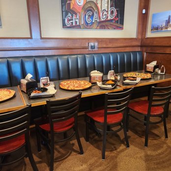Barro's Pizza - a long table with pizzas on it - Pizza Near Me - Peoria, Arizona