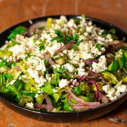 Kabab Spot - Fresh Mediterranean salad with feta, crisp greens, red onion, herbs and olive oil at Kabab Spot Fort Myers, a local favorite for healthy bit