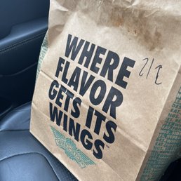 a paper bag with the words where flavor gets its wings