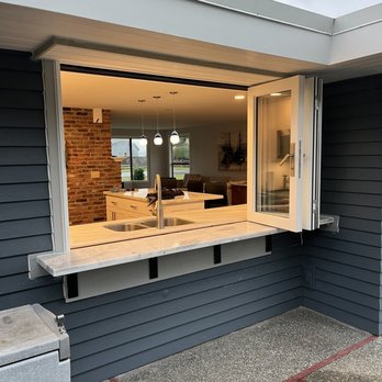 Red Flannel Construction - Custom, tri fold window, allowing the sharing of inside to outside, for warm weather events. - General Contractors Near Me - Oak Harbor, Washington Red Flannel Construction - Custom, tri fold window, allowing the sharing of inside to outside, for warm weather events. - General Contractors Near Me - Oak Harbor, Washington