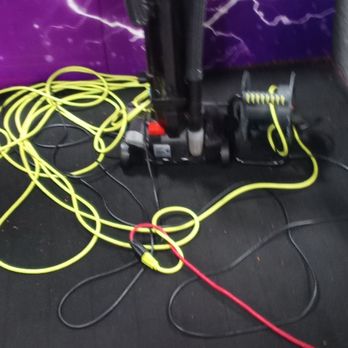 Surge Adventure Park - Vacuum next to entrance of a play area plugged in with the cord stretching across the room - Trampoline Parks Near Me - Opelika, Alabama