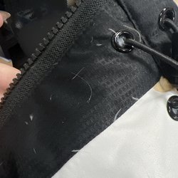 eTc Tacoma - Down feathers leaking from the Redzone x ETC 2023 vest.
