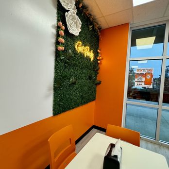 The Peach Cobbler Factory - a table and orange chairs - Desserts Near Me - Daphne, Alabama
