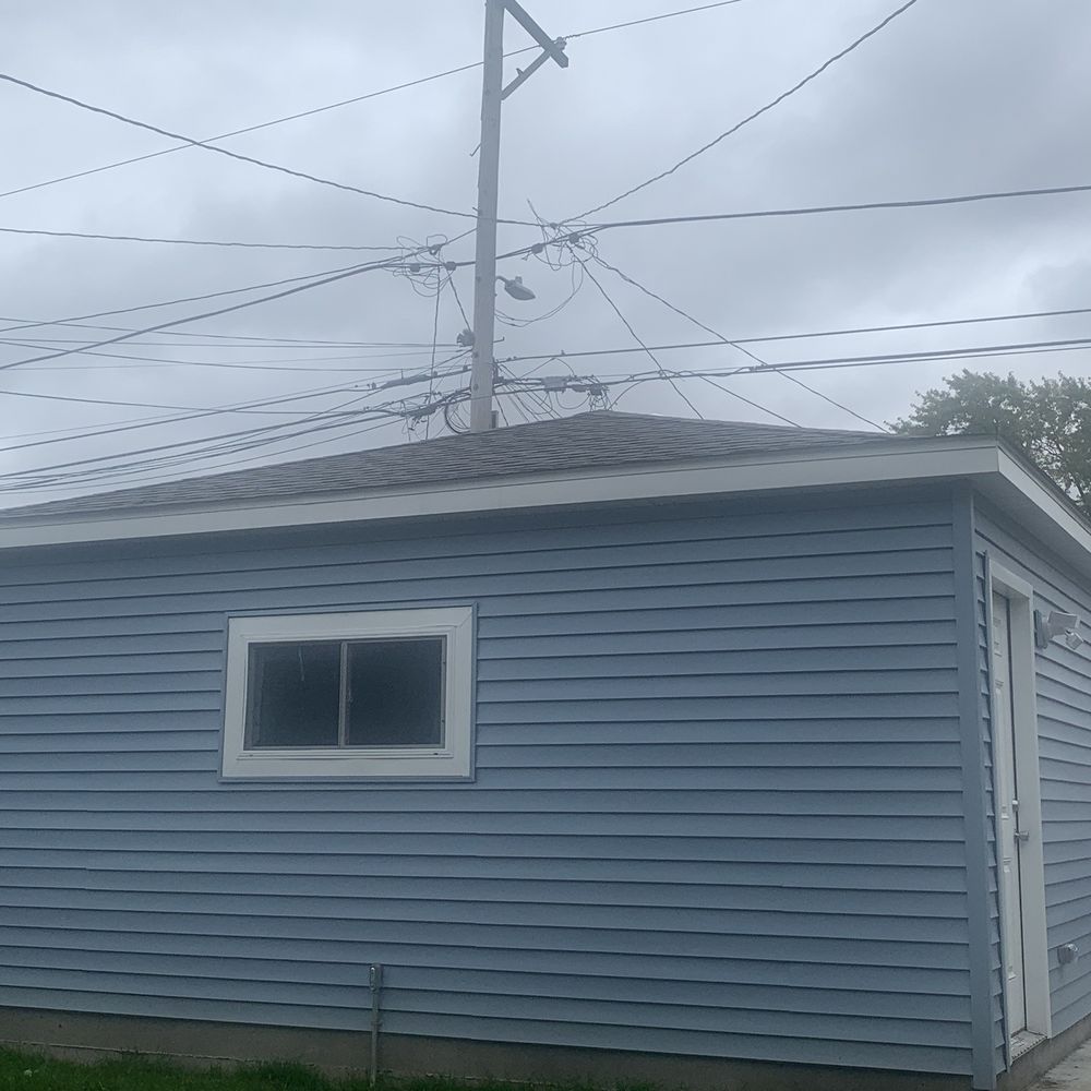Fisher Garages - a blue house with a white window - General Contractors Near Me - Chicago, Illinois Fisher Garages - a blue house with a white window - General Contractors Near Me - Chicago, Illinois