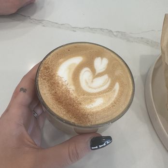 Lightbrite Coffee - a hand holding a cup of coffee - Coffee Roasteries Near Me - Grimes, Iowa