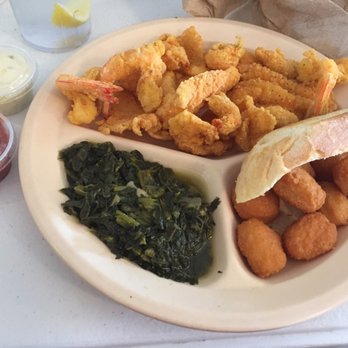 Crawford's Restaurant - Seafood lunch platter (crawfish, shrimp, and catfish) with sides of mustard greens and corn fritters! - Southern Near Me - Baton Rouge, Louisiana