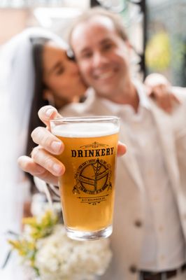 Photo of Bourbon Street Drinkery - New Orleans, LA, US. a bride and groom holding a pint of beer