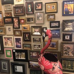 Aladdin's Art Gallery - Aladdin's mascot, Florence the Flamingo admires the wall of mini art.